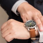 Businessman checking the time on his wrist watch